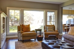 Natural lighting floods a living room with large windows